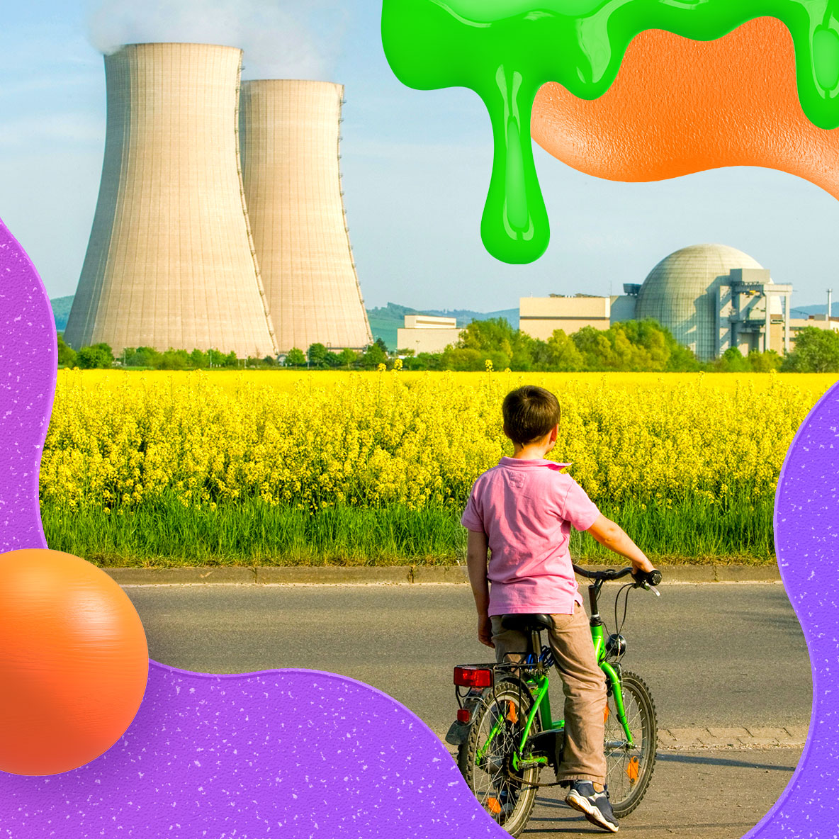 A boy rides a green bicycle and looks out at a power facility over a corn field.